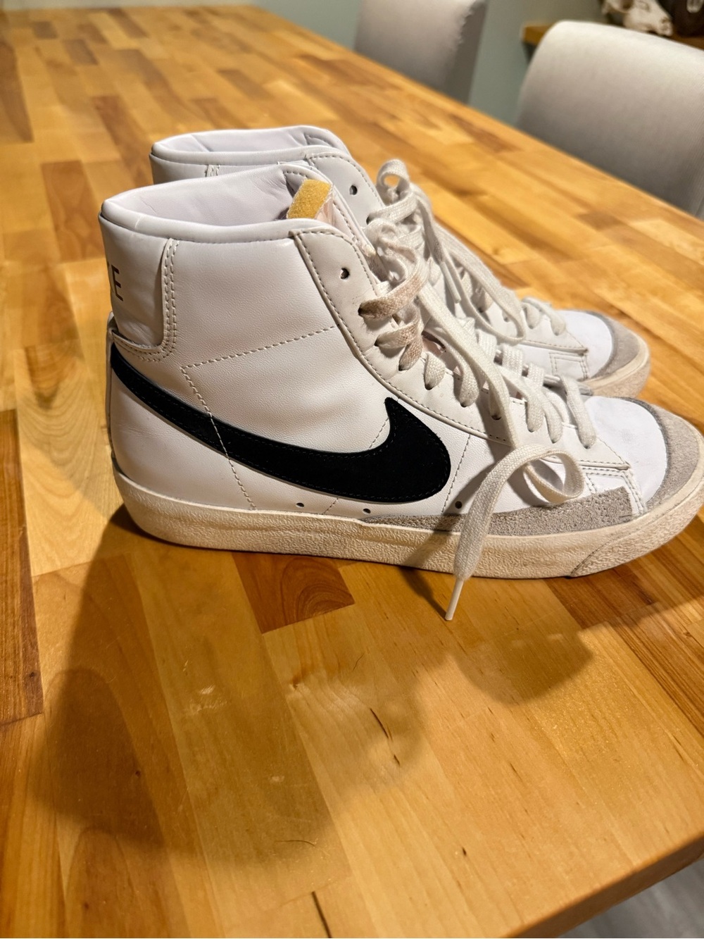 Nike White High-Top Sneakers with Black Swoosh